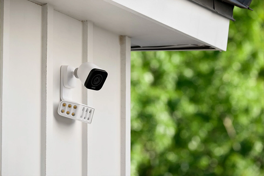 Features like audible warnings and intense lighting displays make the Vivint Spotlight Pro an effective deterrent against burglary. Vivint's Spotlight Pro camera perched on the side of a house with white siding